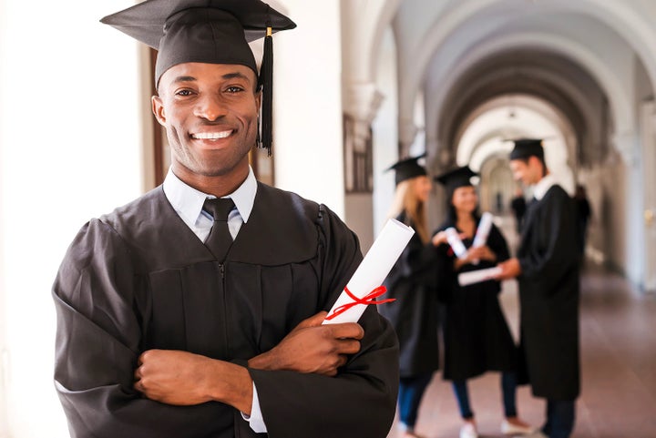 college graduate holding his diploma | Cook Subaru in Steamboat Springs CO