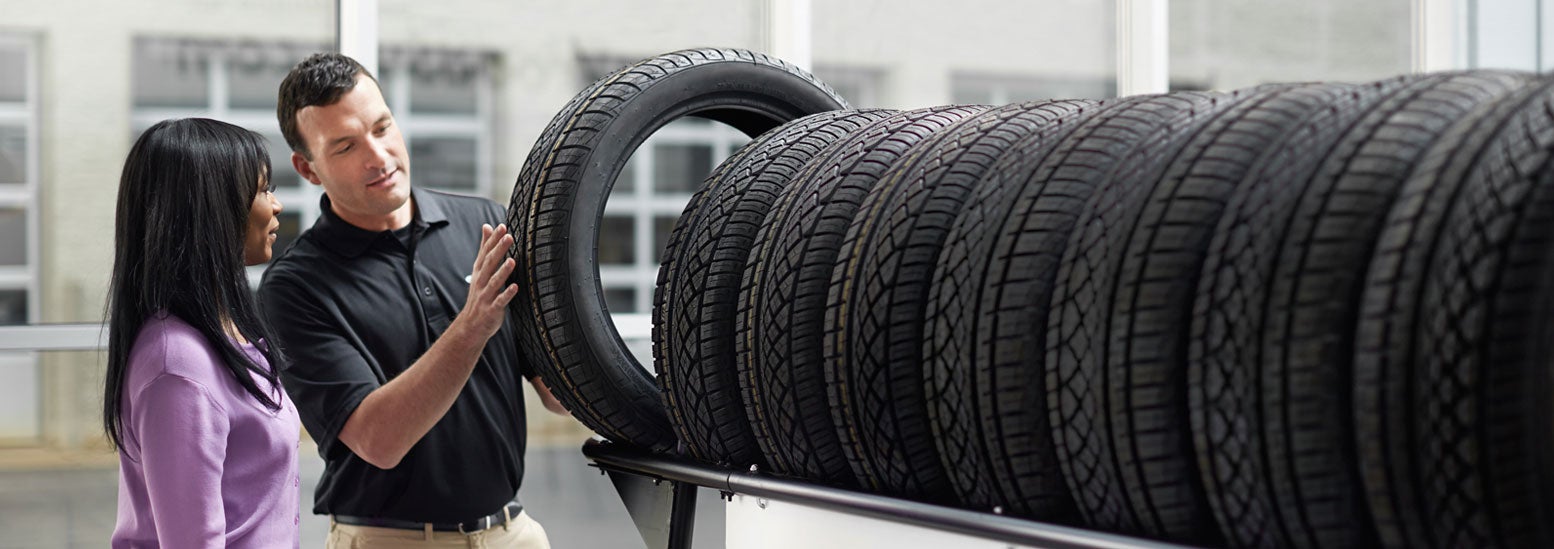 Subaru service representative showing customer a tire. | Cook Subaru in Steamboat Springs CO
